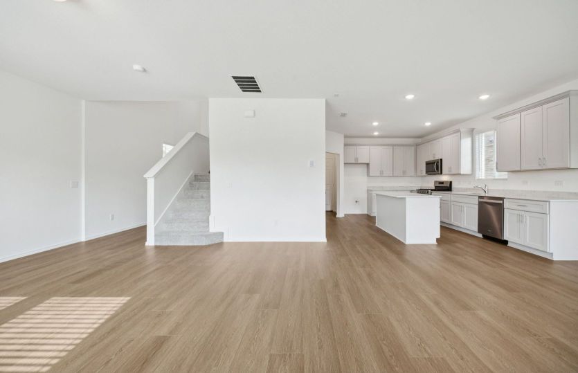Spacious gathering room with view of kitchen