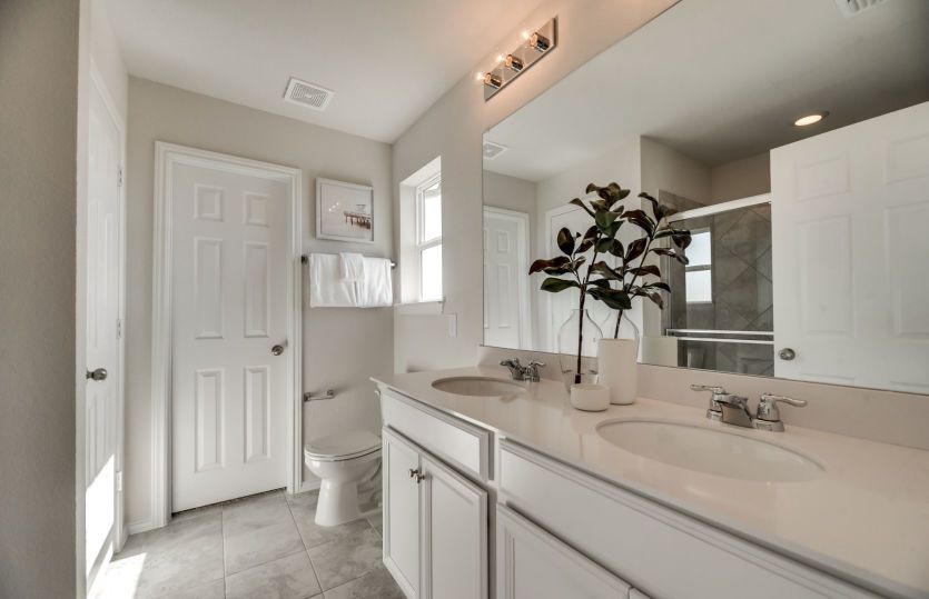 Spacious owner's bath with double vanity and shower