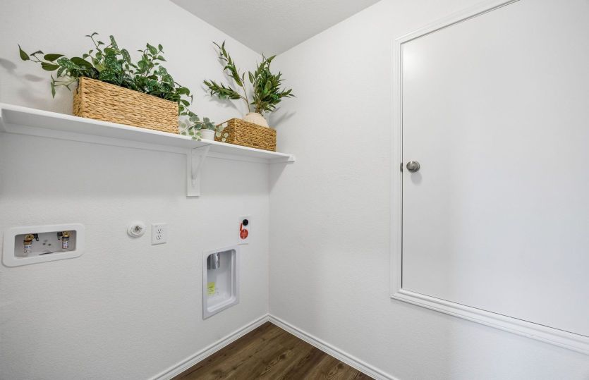 Spacious utility room with built in shelving *model representation