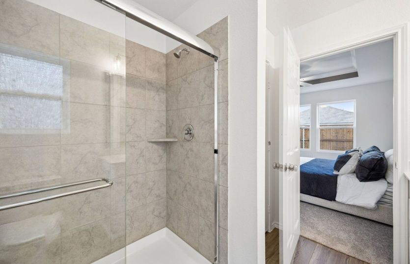 Private primary bath with sliding glass shower *model representation