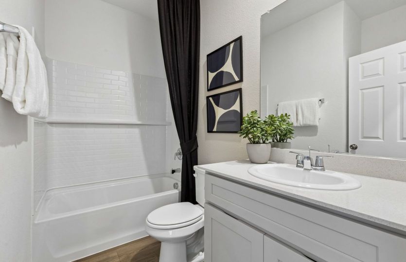 Secondary bath with tile surrounded shower *model representation