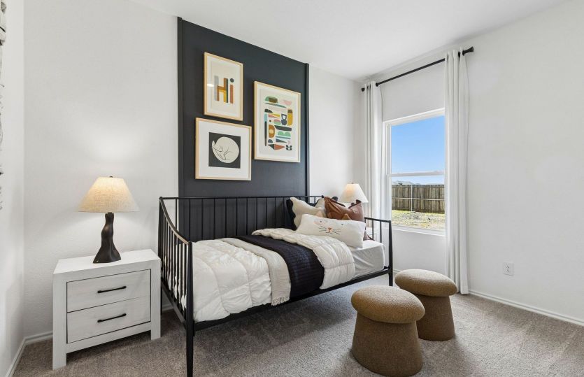 Spacious secondary bedroom with large window *model representation