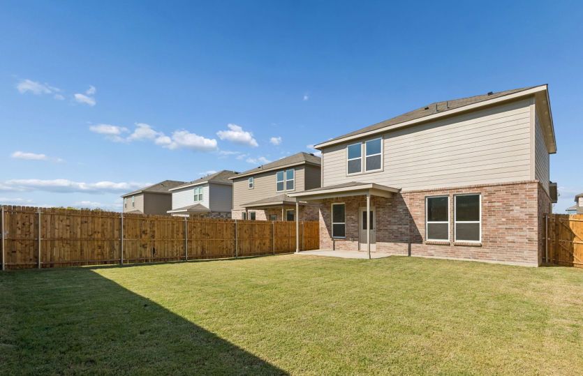 Oversized fenced in backyard with a covered patio