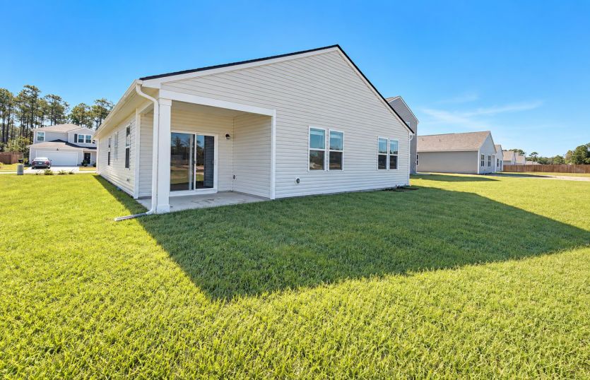 Covered back porch made for relaxing and enjoying the outdoors year-round.