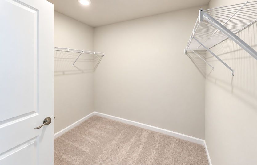 Owner’s suite walk-in closet offering generous storage and organization.