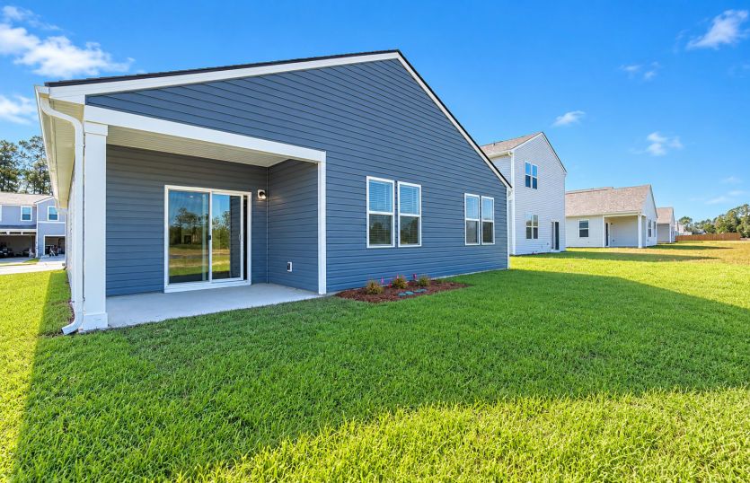 Covered back patio offers a comfortable spot for outdoor relaxation and entertaining.
