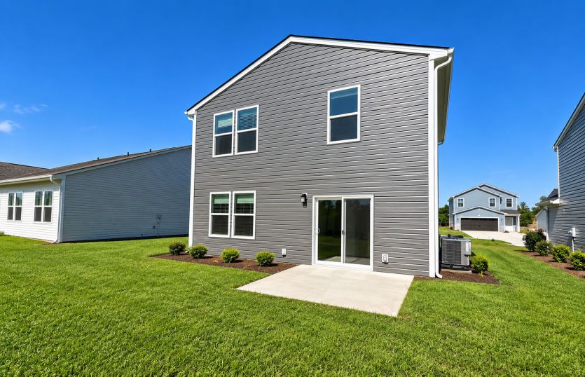 Uncovered back patio provides an open-air setting for relaxing, grilling, or enjoying the backyard.