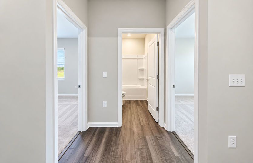 Thoughtfully arranged hallway connecting the secondary bedrooms and bath.