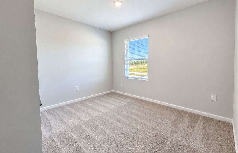 Secondary bedroom offering a comfortable space for family or guests.