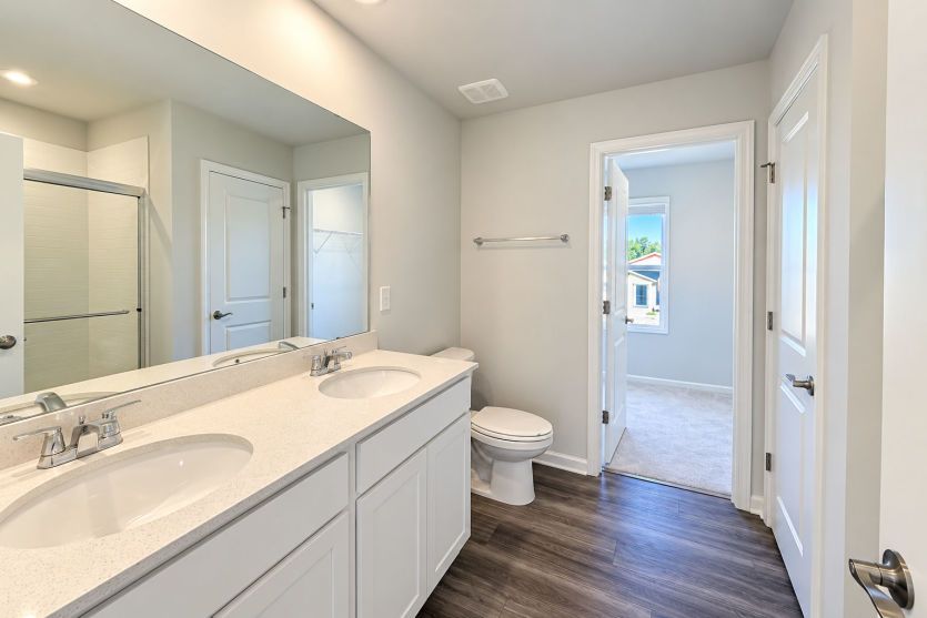 Owner’s bath creates a relaxing retreat with a clean, refined finish.