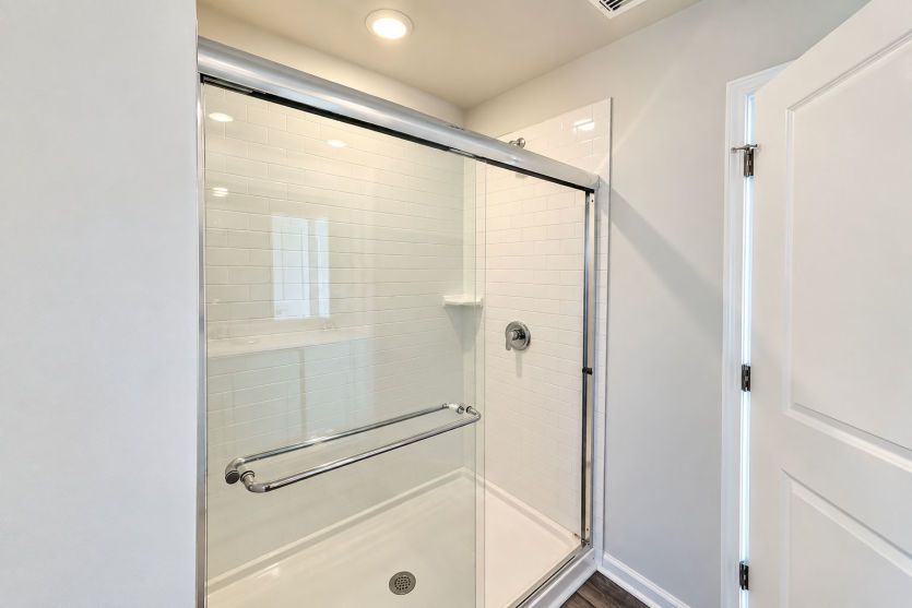 Walk-in shower brings a sleek, spa-inspired touch to the owner’s bath.