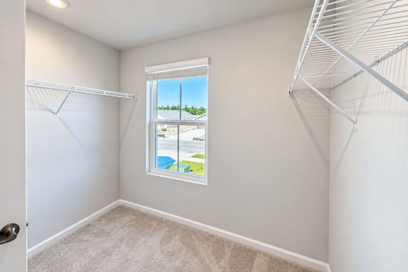 Walk-in closet keeps the owner’s suite organized with generous storage space.