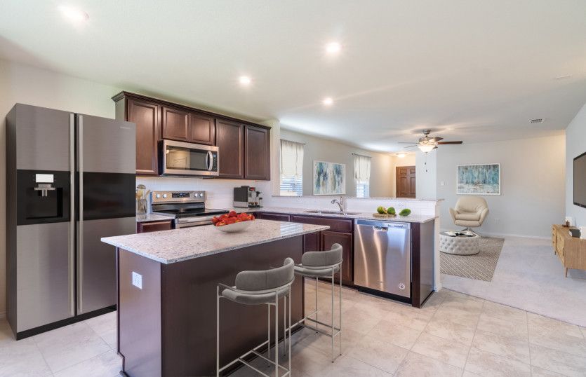 Island kitchen with abundant cabinet space *model representation