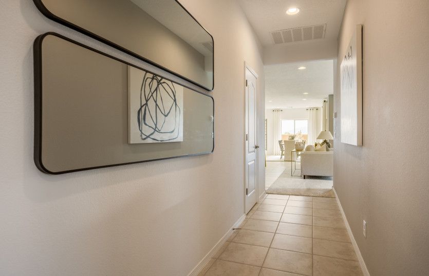 Enter the Verbena to a quint foyer that leads you to the secondary bedrooms and the main living area