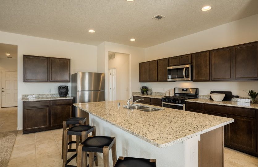 The kitchen boasts ample storage space thanks to the attached pantry and cabinets.