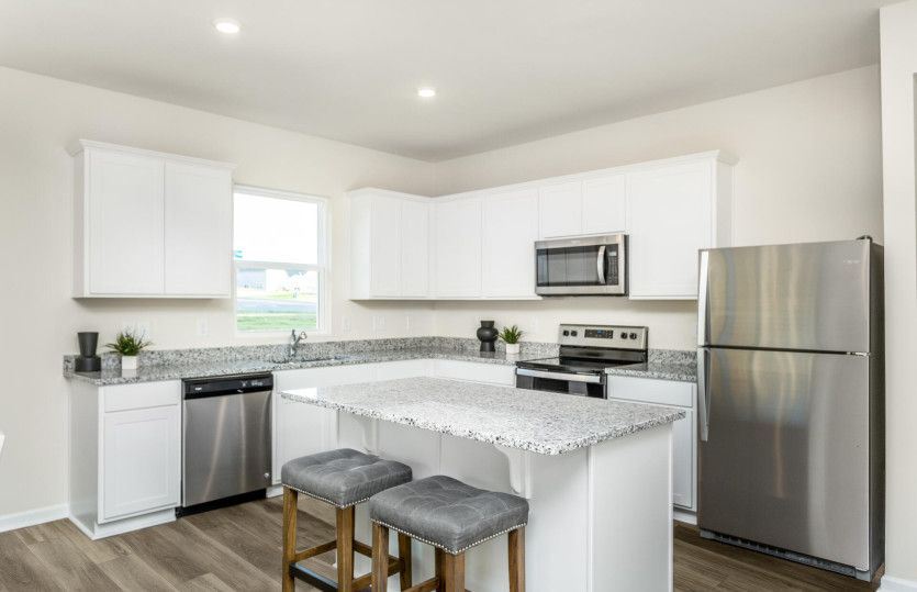 Kitchen with white cabinets and granite countertops.