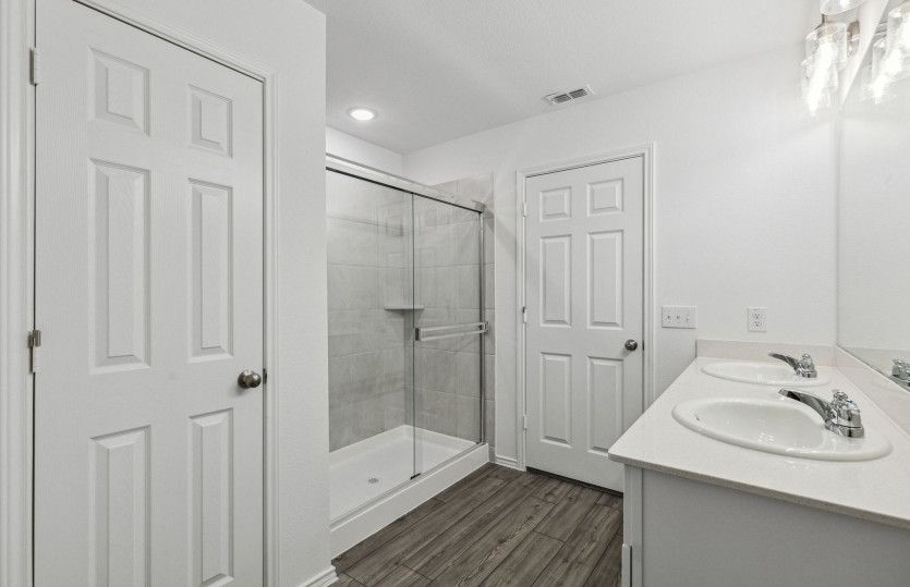 Owner's private bath with double vanity and spacious shower
