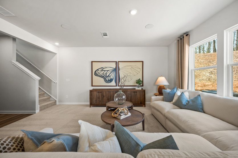 The gathering room, with expansive windows, creates a warm and welcoming space that is perfect for q