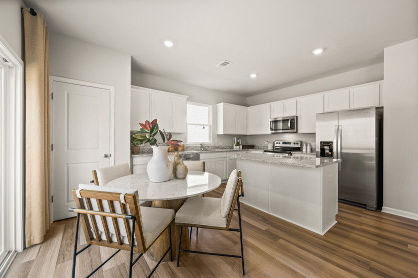A cozy café nook that seamlessly transitions into the open kitchen.