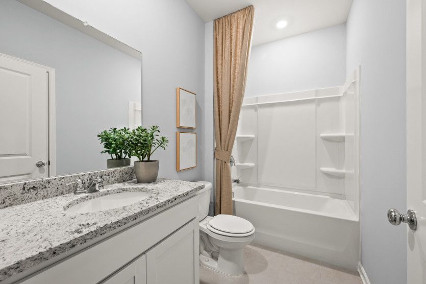 Maximize convenience with a secondary bathroom that offers both practicality and elegance.