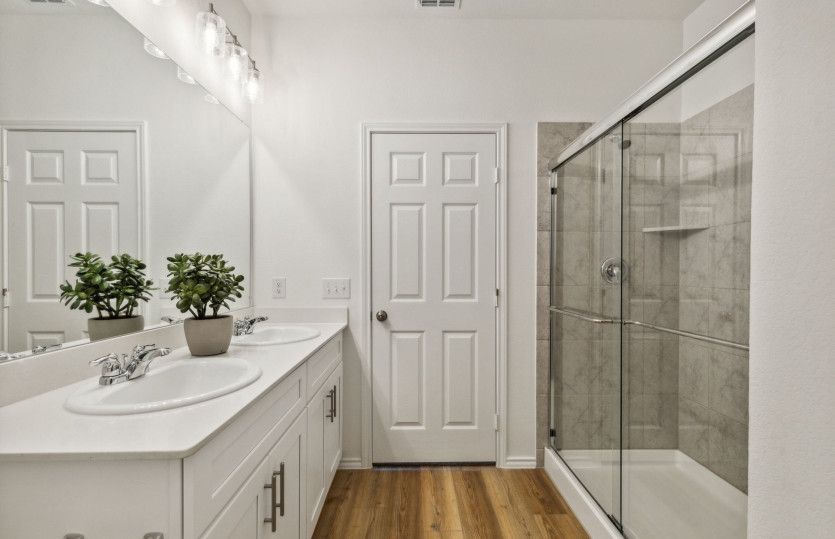 Owner's private bath with large shower*model representation