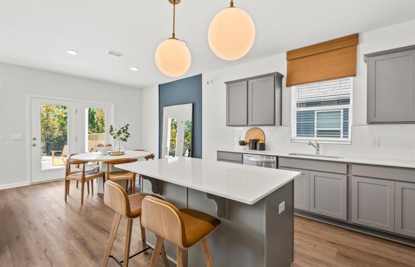 Beautiful Open Kitchen with an island and natural gas stainless steel appliances.