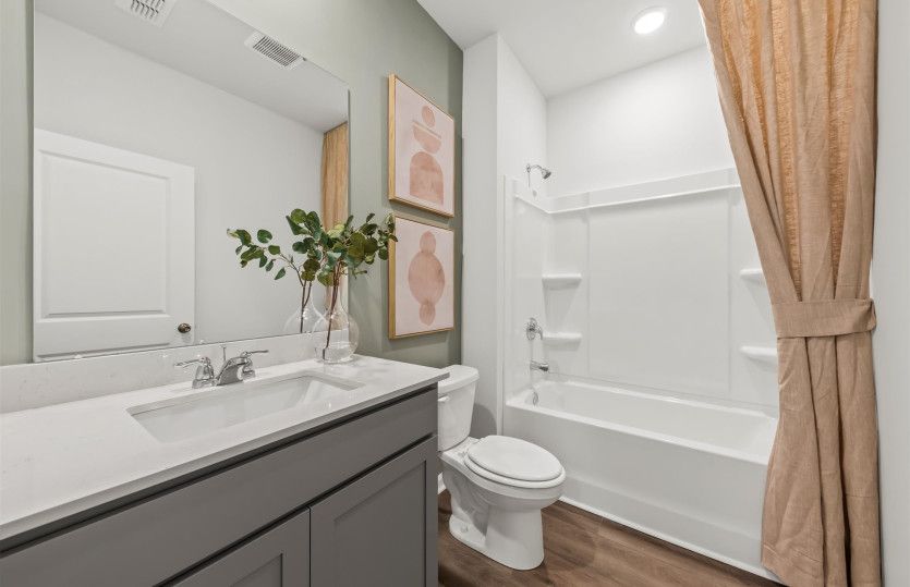 Unwind in the comfort of a spacious tub in this secondary bathroom—perfect for a relaxing soak after