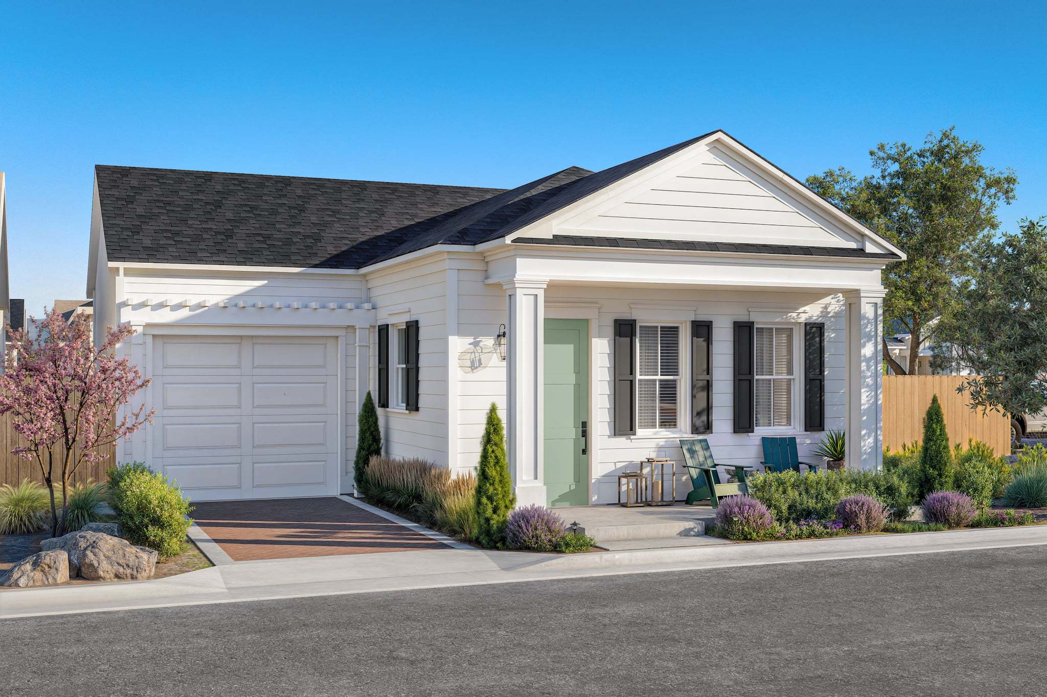 The Monet Colonial Cottage exterior with welcoming front porch and landscaped entry at Bellecrest 55+ community in Santa Maria.