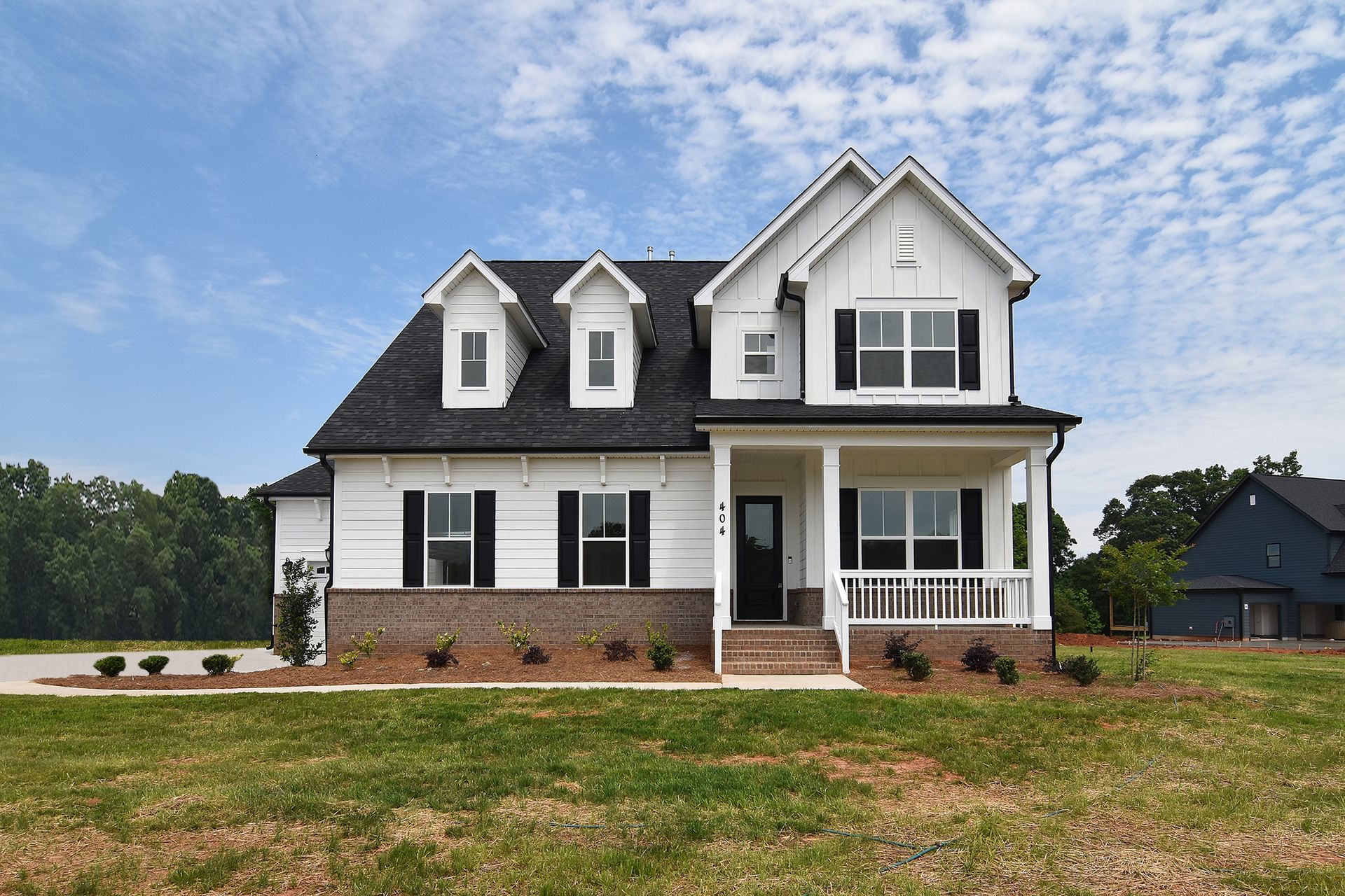The Bethpage is an elegant master-down plan with 10' ceilings downstairs, a beautiful epicurean kitchen, and 