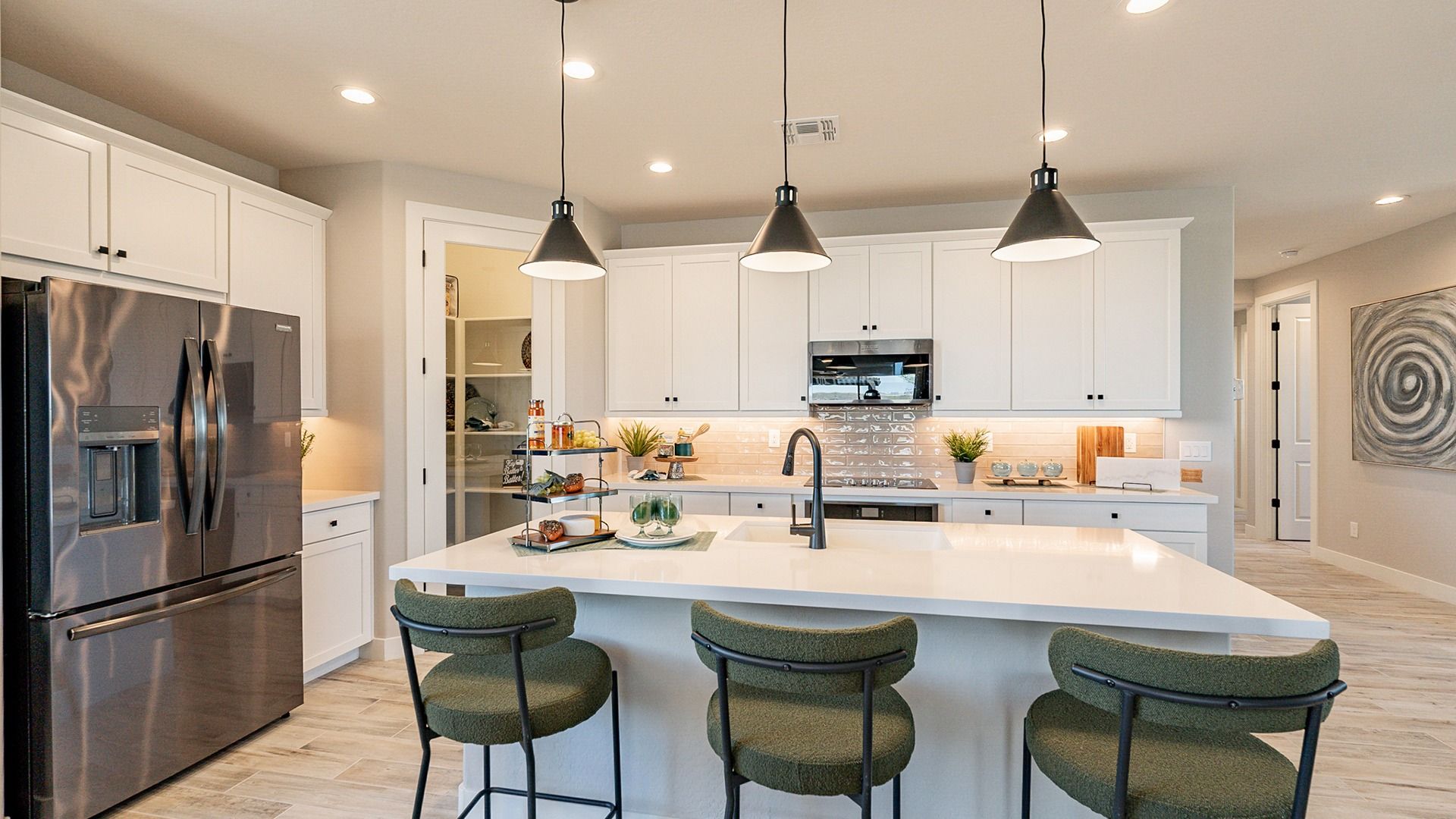 Experience refined elegance with sleek stone countertops and stylish pendant lighting in Sienna Park's kitchen.