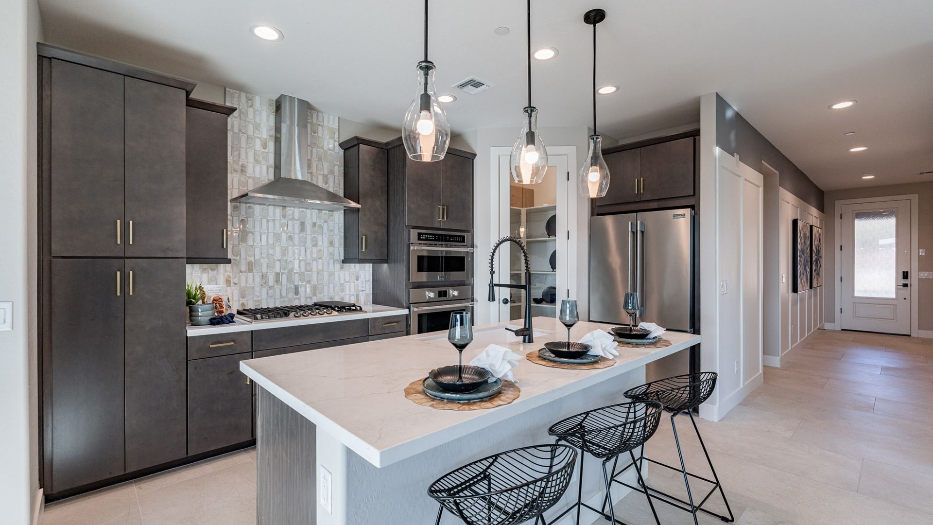 Experience luxury with quartz countertops, elegant pendant lights, and custom cabinetry in Mystic's elite residence.