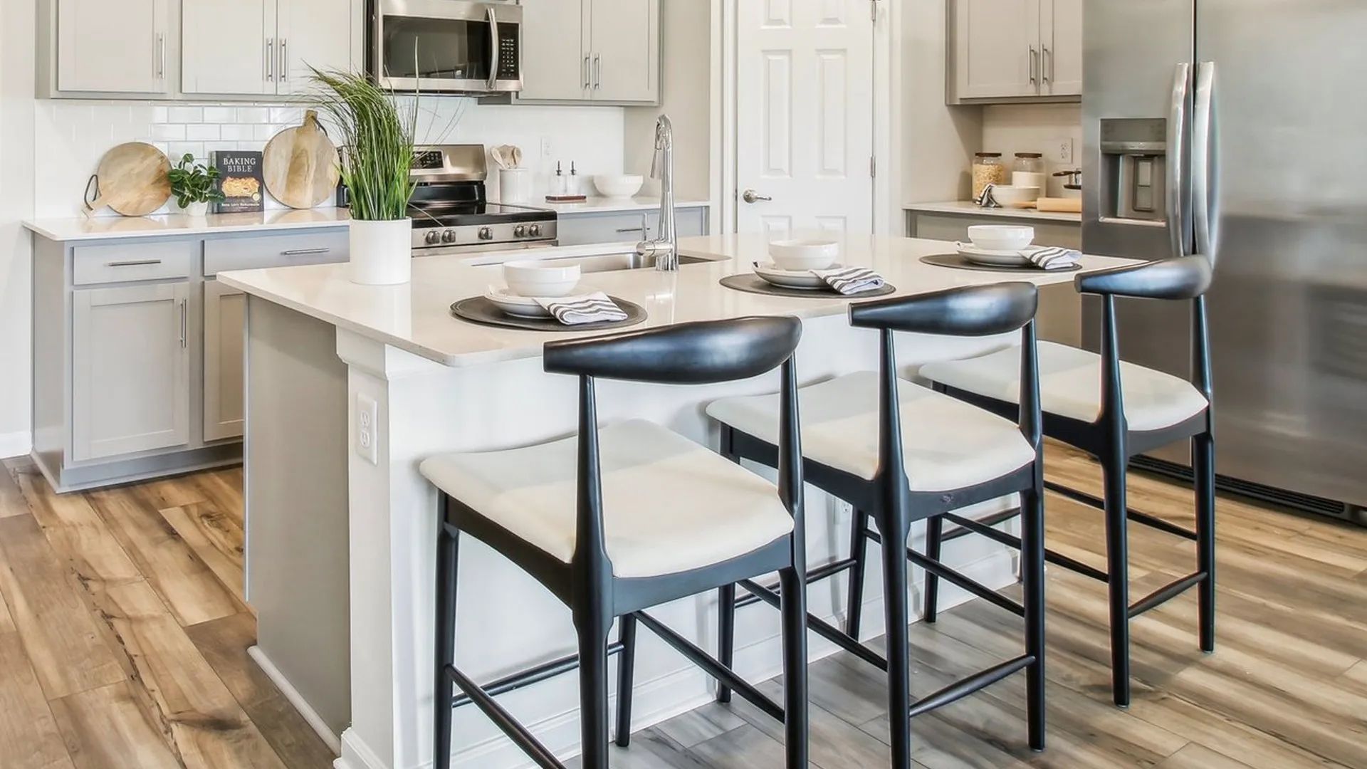 Experience luxury with sleek cabinetry, stainless steel appliances, and elegant island seating in Surprise City Center.