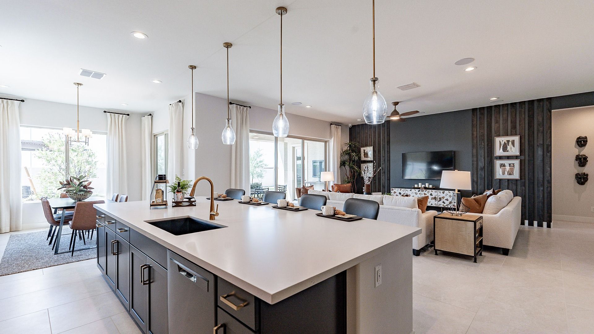 Exquisite kitchen features large island, sleek pendant lights, and chic dining in Windrose.