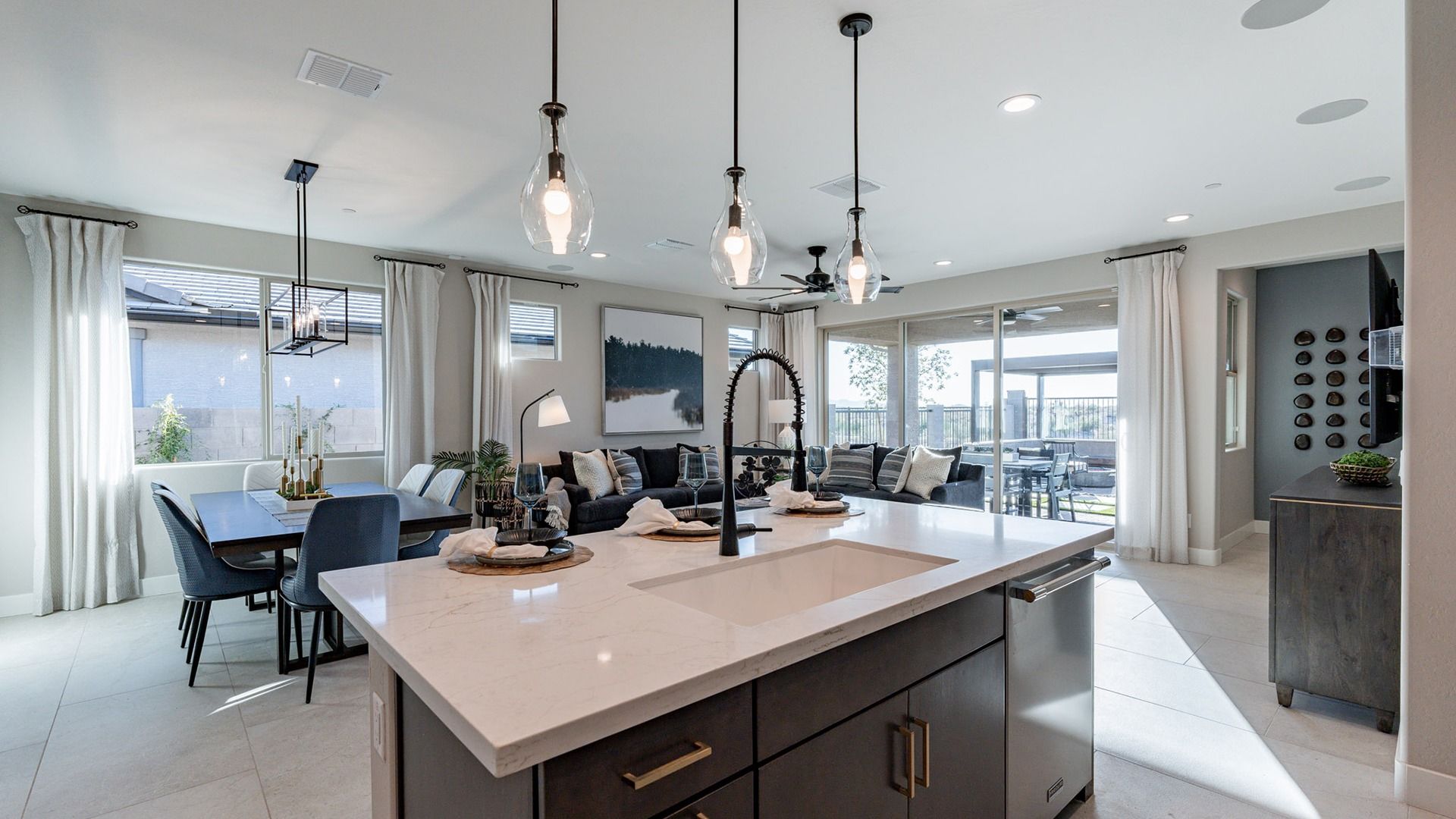 Luxurious design featuring elegant pendant lights and marble countertops in The Villas at Mystic.