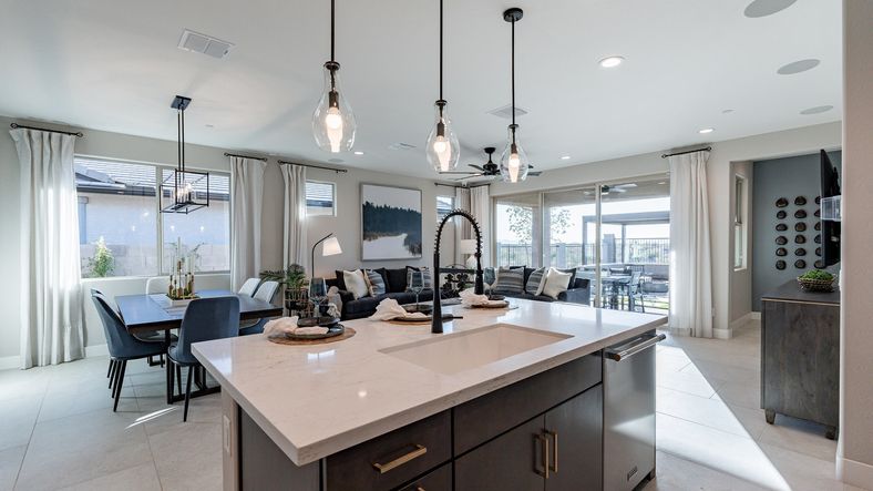 Luxurious design featuring elegant pendant lights and marble countertops in The Villas at Mystic.