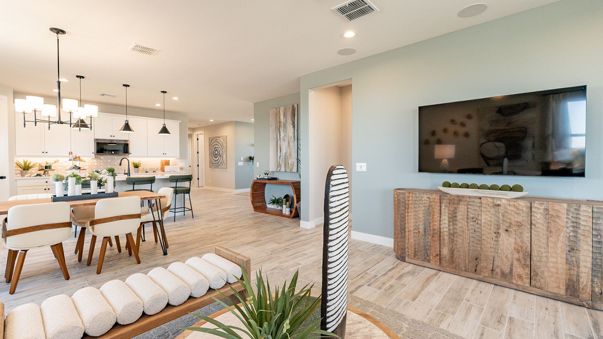 Elegant open-plan design features high-end lighting, rustic accents, and sleek finishes in Sienna Park.