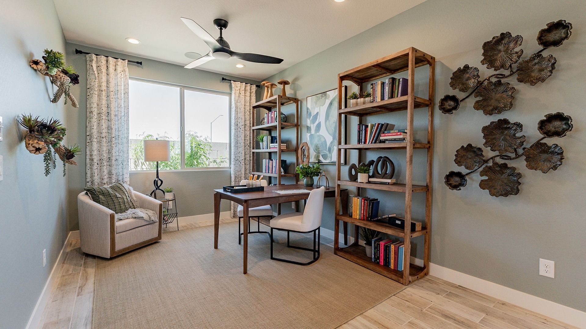 Revel in the sophistication of this Sienna Park office featuring wooden shelving, metal accents, and serene natural light.