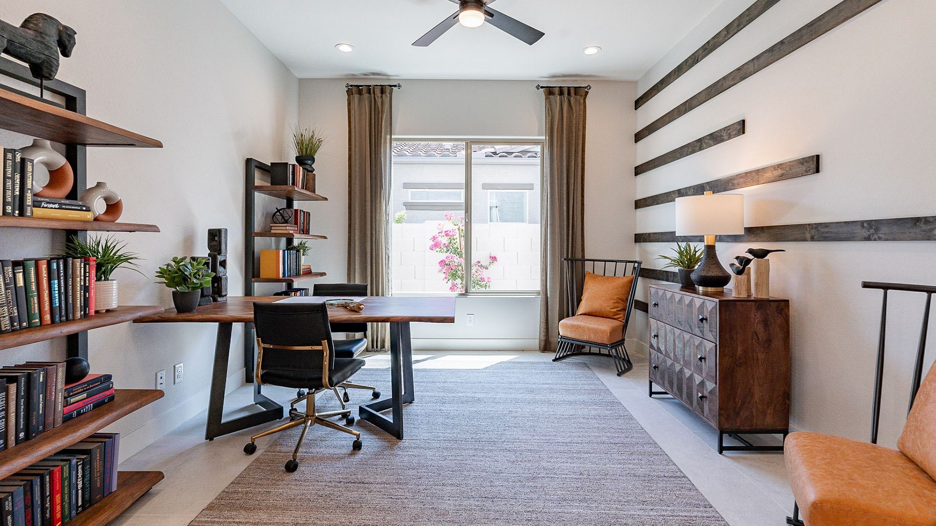 Exquisite office features custom wood accents, sleek furnishings, and designer lighting in Windrose.