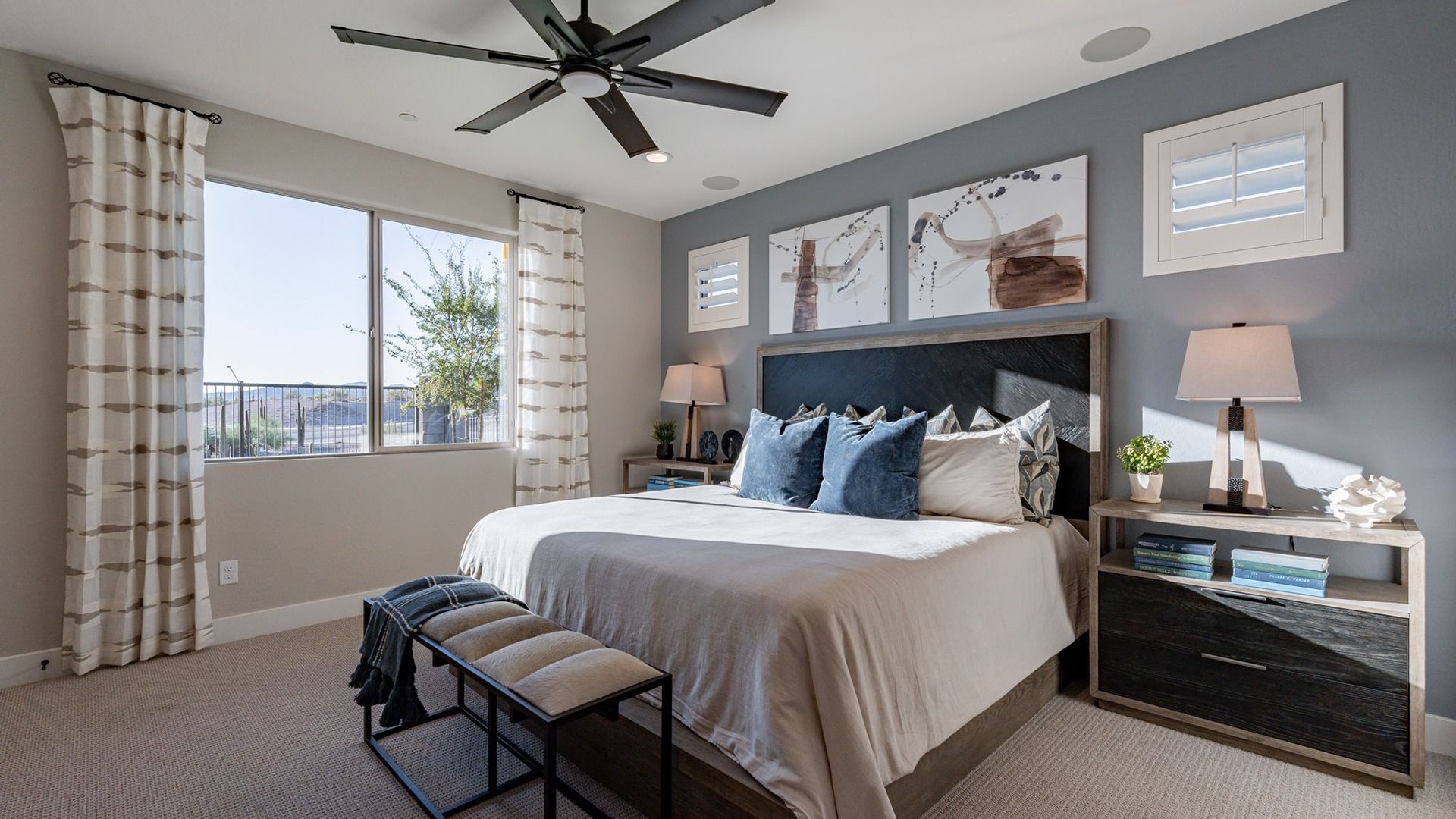 Enjoy sophisticated design with plush fabrics and contemporary art in this Mystic Villas bedroom.