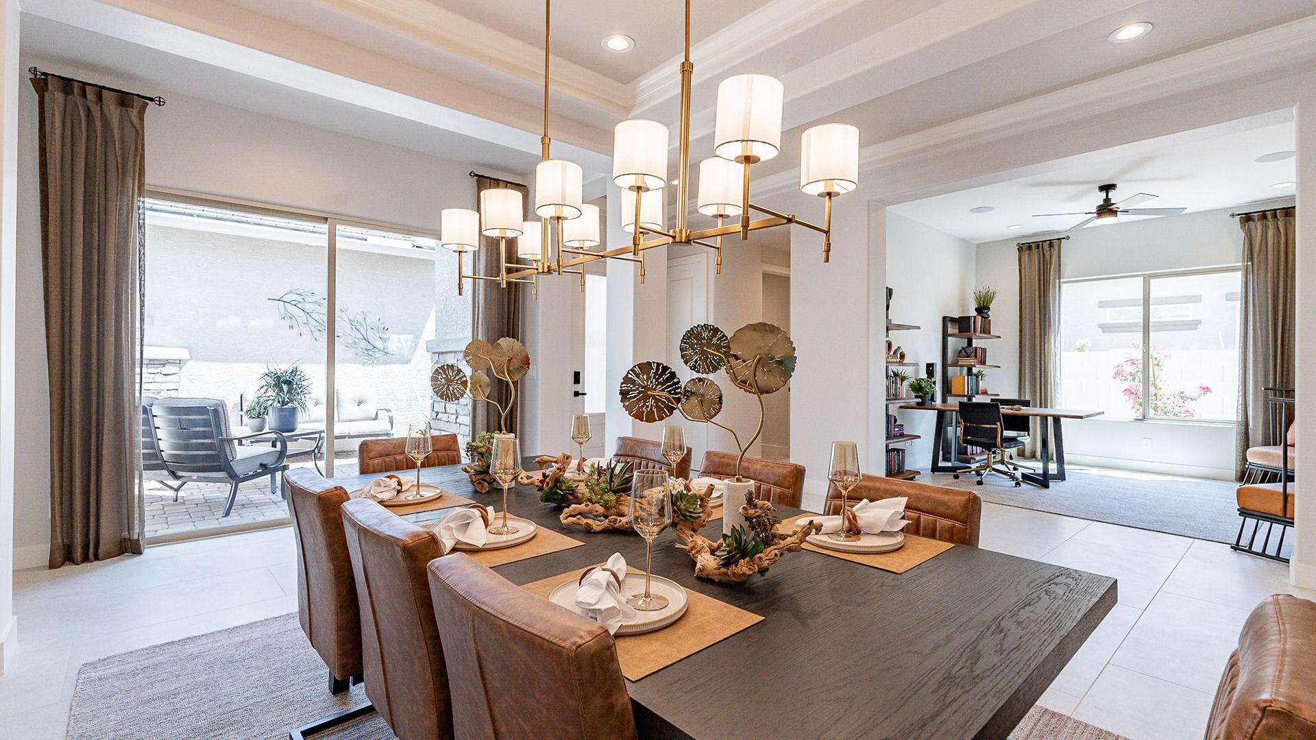 Experience refined elegance with chic lighting and supple leather seating in this Windrose dining space.