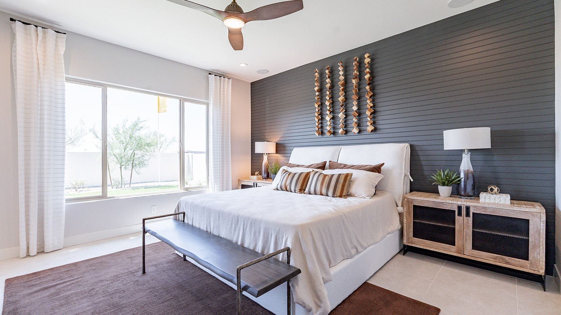 Experience tranquility in Windrose with a chic accent wall, expansive window, and plush textiles. Indulge in luxury.