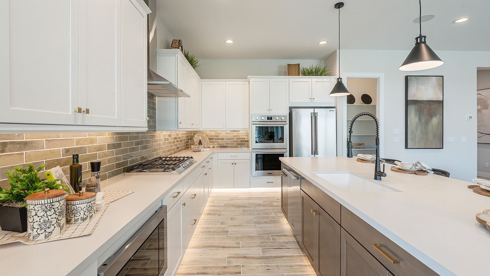 Luxurious kitchen with sleek white cabinetry and premium fixtures in Hacienda at Estrella.