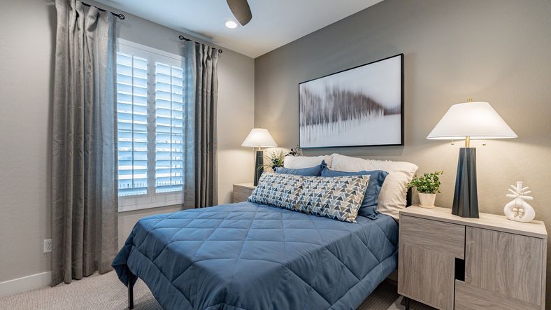 Elegant bedroom with chic decor, plush bedding, and ambient lighting in The Villas at Mystic.