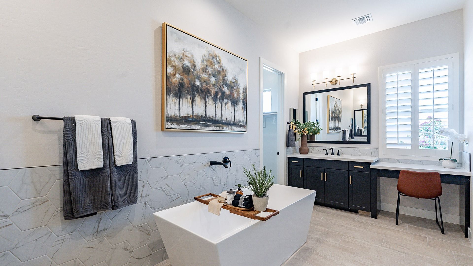 Discover sophistication with a freestanding tub, hexagonal marble tiles, and custom double vanity in Windrose.