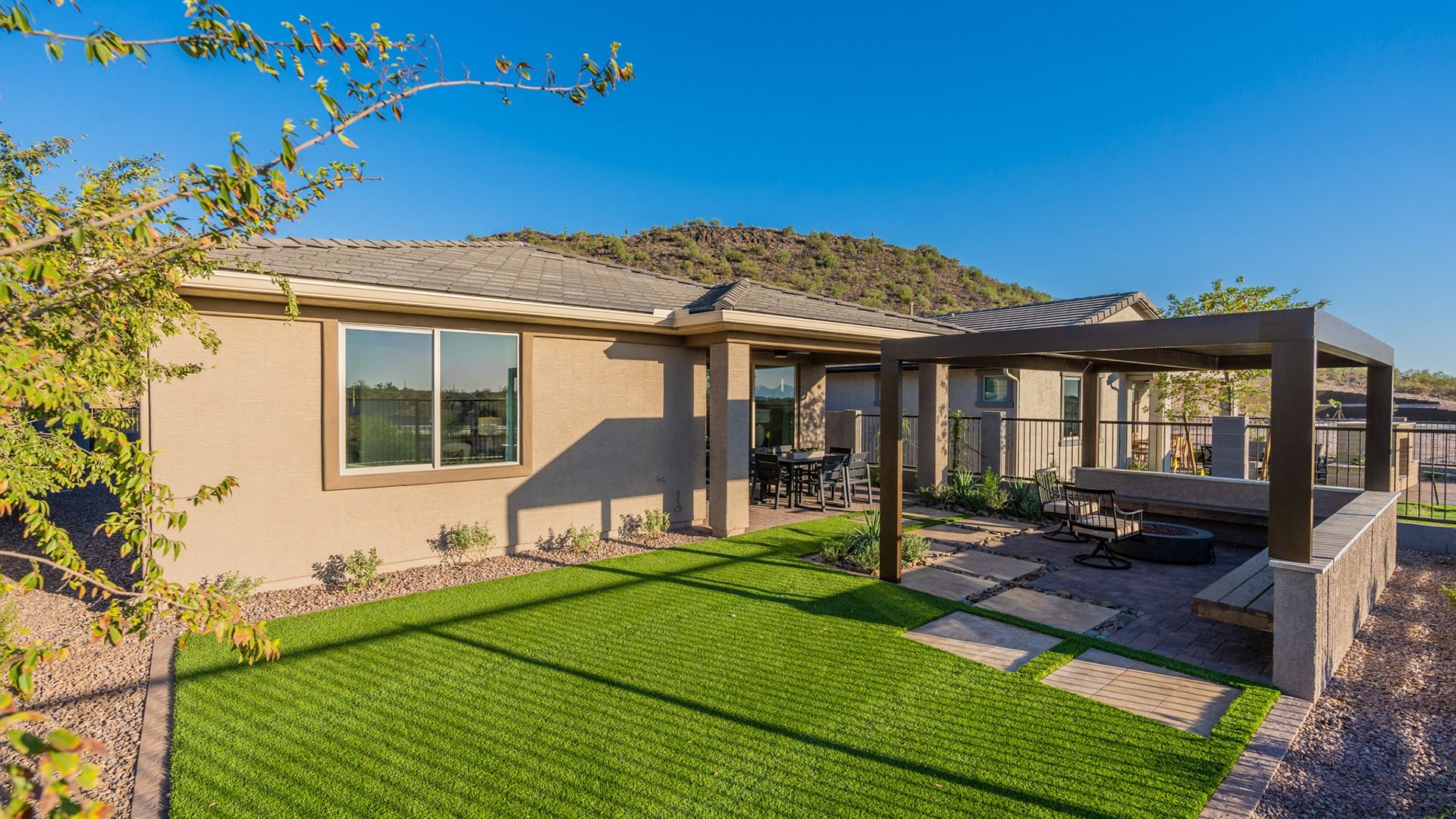 Elegant pergola and pristine lawn define the luxurious outdoor space at The Villas at Mystic, Arizona.