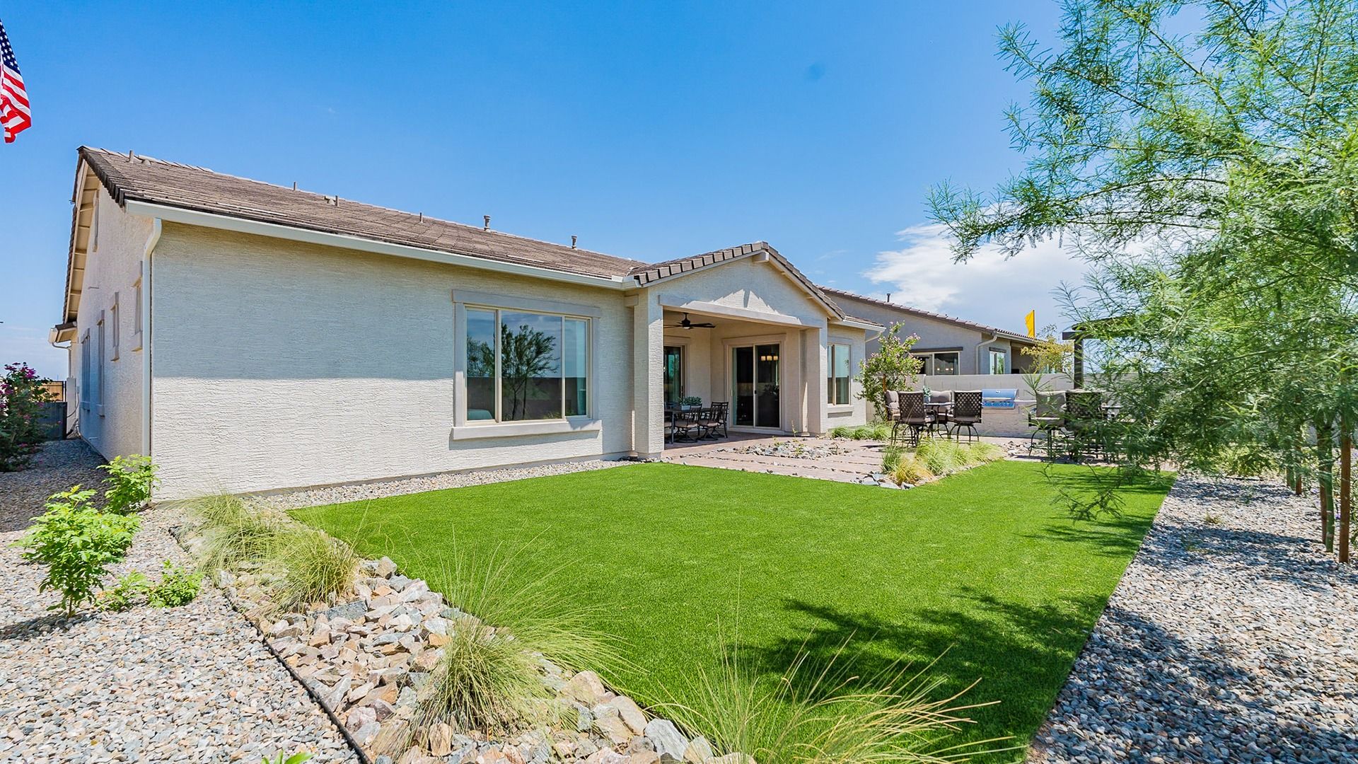 Experience elegance with lush lawns and desert-inspired landscape in this Windrose residence.