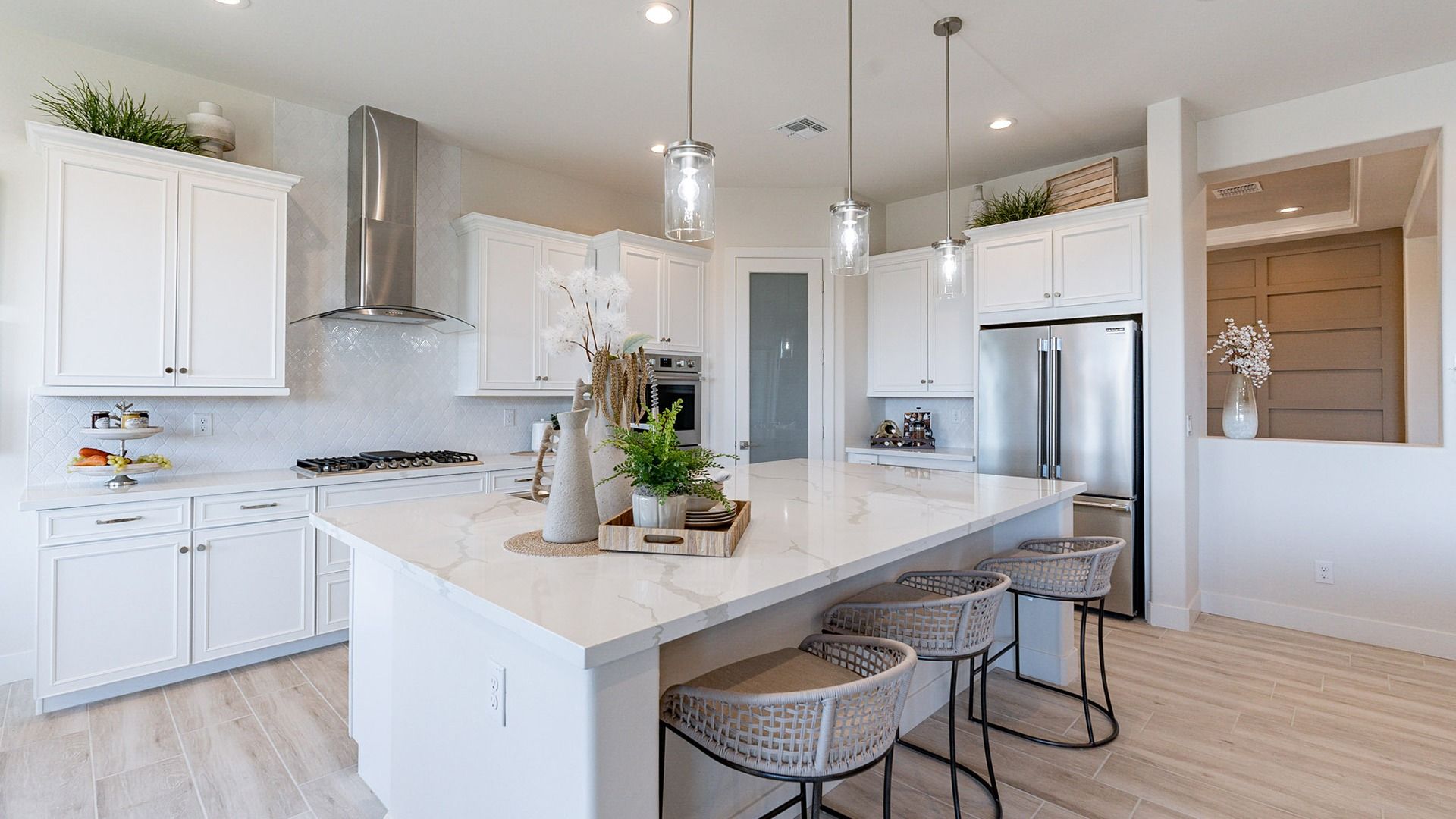 Windrose kitchen with quartz countertops, custom cabinetry, and elegant pendant lighting for sophisticated charm.