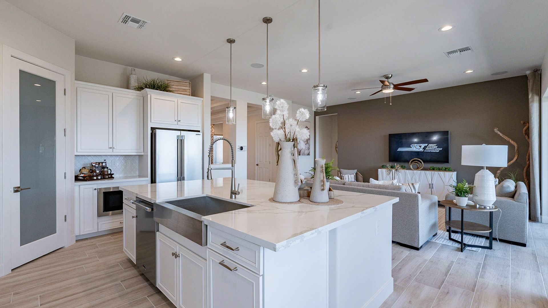 Exquisite open-plan layout with marble countertops, stainless fixtures, and elegant pendant lighting. Windrose community.