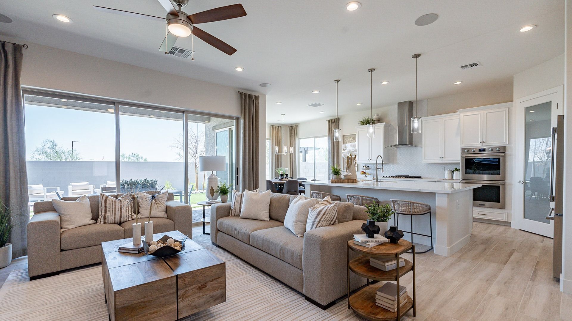 The Windrose home boasts open-concept design, sleek wood floors, and expansive windows for luxurious living.