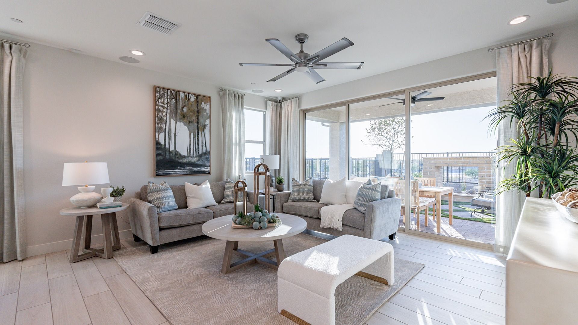 Experience luxury with expansive glass doors, elegant neutral tones, and plush furnishings at Villas at Mystic.